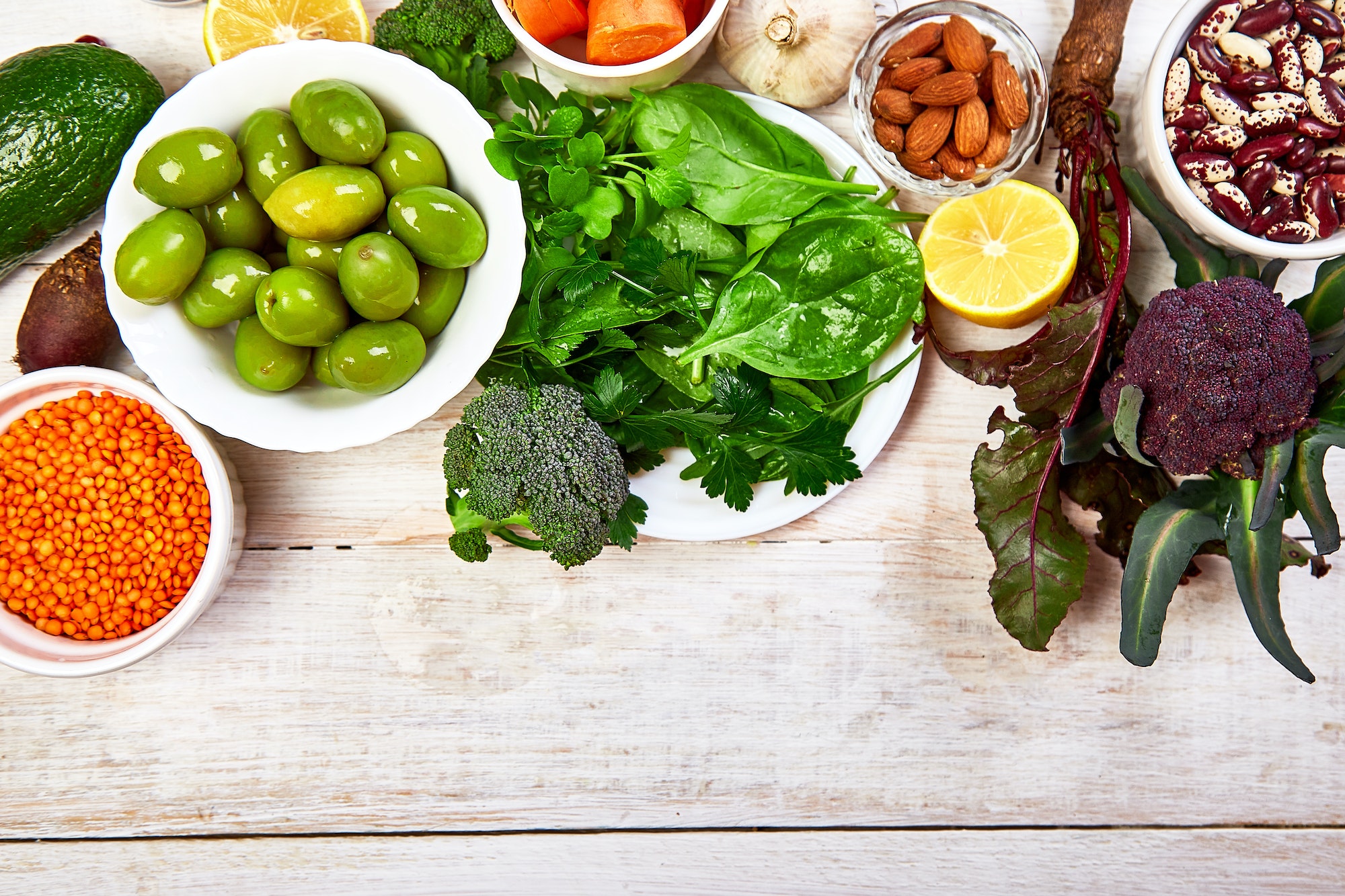 Foods for healthy liver on white wooden background.